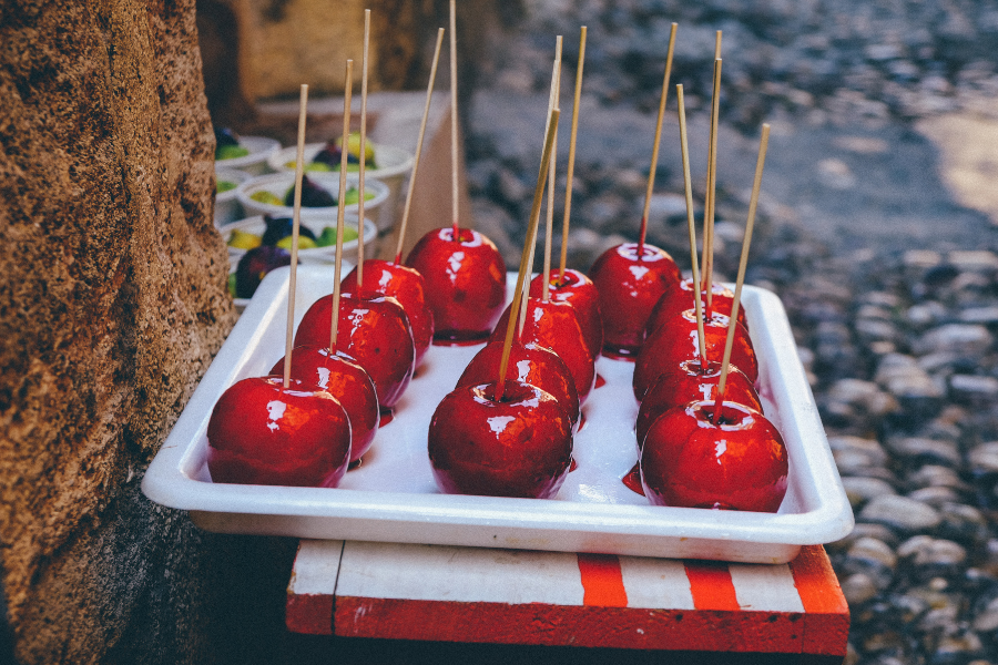 Recipes Parent waves: 1. Introduction There's something undeniably enchanting about Classic Red Candy Apples. These glossy, crimson delights are not just a treat; they're a trip down memory lane, a symbol of festive seasons and childhood joy. Whether it's the crackling sound of the candy shell giving way to a juicy apple or the sticky fingers that follow, each bite is a blend of nostalgia and sweetness. In this recipe, we'll revisit this timeless classic, perfect for Halloween, fall fairs, or any day when you crave a sweet, nostalgic treat. Let's embark on this sugary journey and create magic with apples and candy! 2. Ingredients 8 medium apples (firm variety like Granny Smith) 8 wooden sticks 2 cups granulated sugar 3/4 cup water 1/2 cup light corn syrup Red food coloring (a few drops) 1/2 teaspoon cinnamon extract (optional) 3. Directions Wash and thoroughly dry the apples. Insert wooden sticks into the stem end of each apple. Line a baking sheet with parchment paper. 4. How to Prepare In a medium saucepan, combine sugar, water, and corn syrup. Cook over medium heat, stirring until sugar dissolves. Bring to a boil without stirring. Add red food coloring and cinnamon extract. Continue boiling until the mixture reaches 300°F (hard-crack stage). Remove from heat. 5. Preparation Time Total Time: Approximately 30 minutes Cooking Time: 20 minutes Cooling Time: 10 minutes 6. Servings This recipe yields 8 candy apples. 7. FAQs Q: Can I use any type of apple? A: Firm apples like Granny Smith are best as they hold up well to the heat of the candy. Q: How do I know when the candy mixture is ready? A: Use a candy thermometer; it's ready when it reaches 300°F, known as the hard-crack stage. Q: Can I add flavors to the candy coating? A: Yes, cinnamon extract or vanilla can be added for extra flavor. Q: How long do candy apples last? A: They are best enjoyed within 24 hours but can last up to 3 days if stored in a cool, dry place. Q: Can I make these in advance for a party? A: Yes, prepare them a day ahead and keep them at room temperature. 8. Conclusion Classic Red Candy Apples are more than just a sweet treat; they're a celebration of simpler times and cherished memories. This recipe brings back the joy of homemade delights, perfect for sharing with loved ones. Whether you're hosting a Halloween party, contributing to a school fair, or simply indulging in a sweet craving, these candy apples promise to be a hit. The combination of a crunchy candy shell and a fresh, juicy apple is a timeless classic that never fails to delight. So, grab your ingredients and let's create some sugary magic!